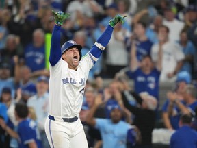 Toronto Blue Jays' George Springer reacts after hitting a three-run homer in Toronto, Oct. 20, 2025.