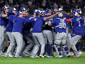 The Toronto Blue Jays celebrate on the field after defeating the New York Yankees in Game 4 of the American League Division Series at Yankee Stadium on Wednesday. Al Bello/Getty Images