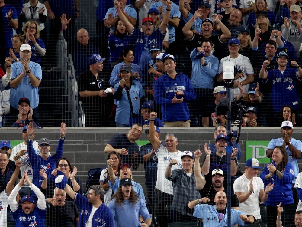 Fans react during the eighth inning of Game 6 of the AL Championship Series between the Seattle Mariners and Toronto Blue Jays at the Rogers Center in Toronto, Sunday, October 19, 2025.