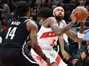 Brandon Ingram of the Raptors (right) works with Terence Mann of the Nets (left) during the first half of NBA preseason action in Toronto, Friday, Oct. 17, 2025.