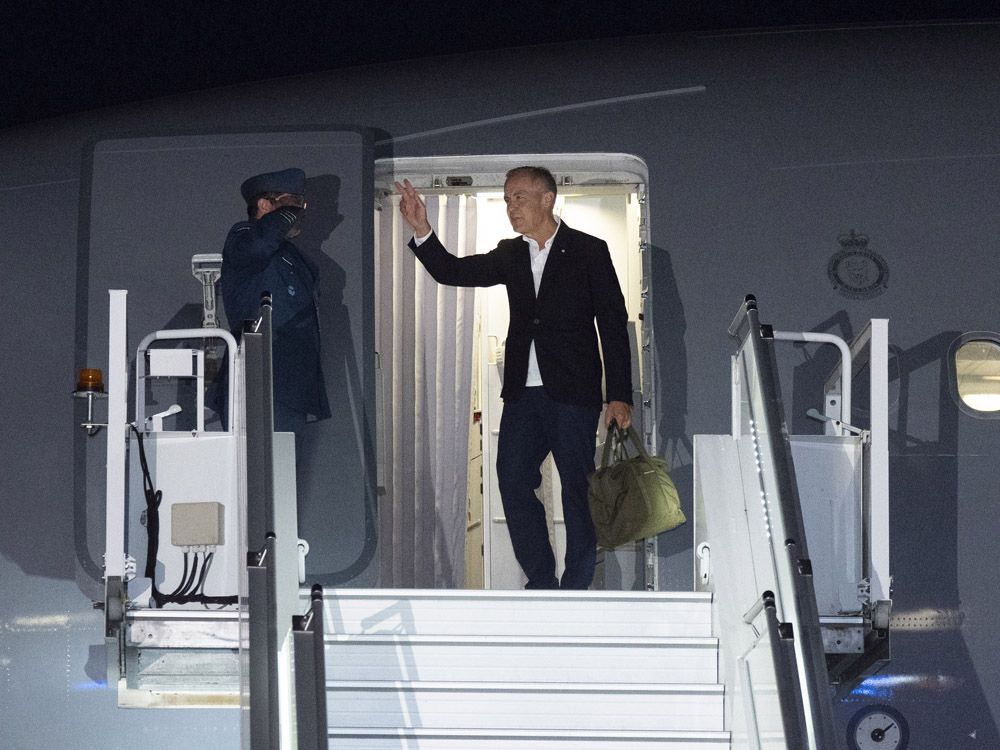 Prime Minister Mark Carney boards a government plane as he departs for Poland, Germany and Latvia from the airport in Ottawa on Saturday, Aug. 23, 2025. 