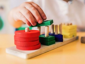 Kid playing with wood toys at pre school classroom. Kindergarten education smart games for children