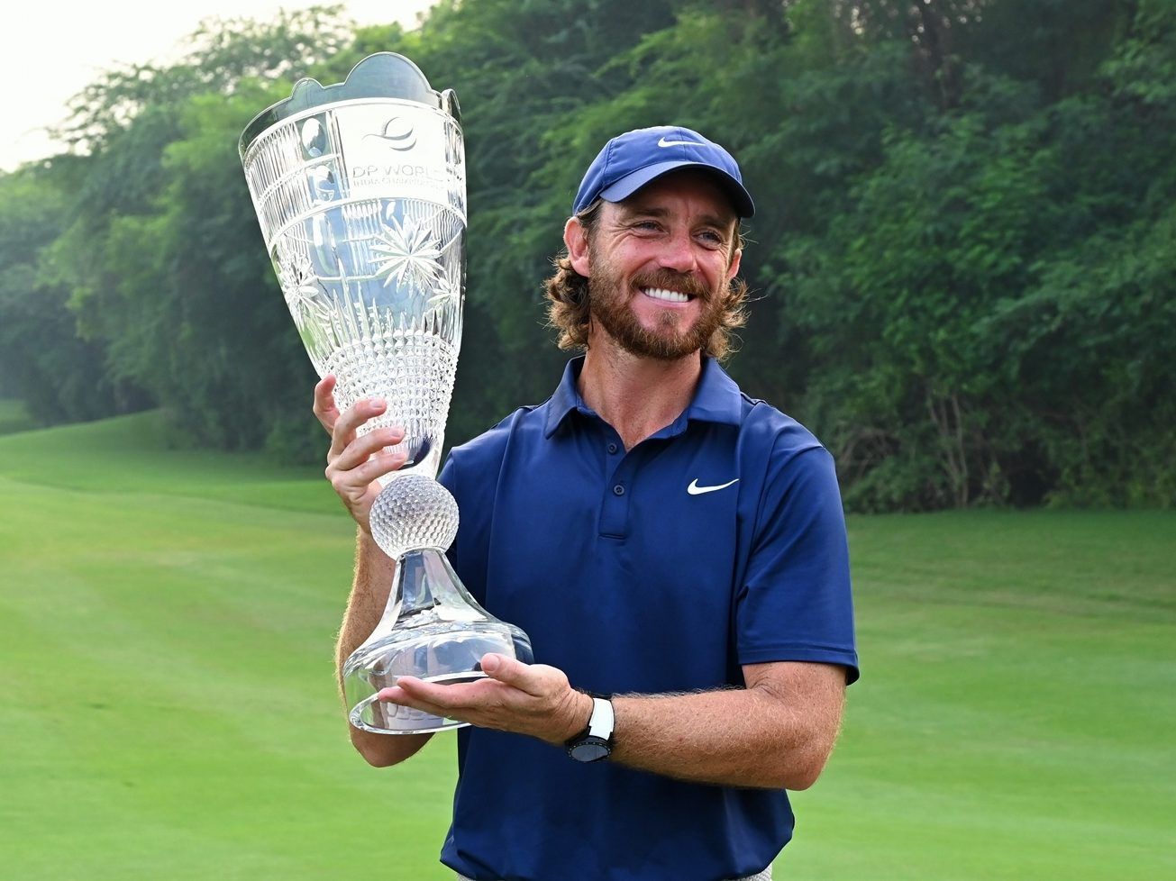 Tommy Fleetwood of England poses with the trophy after winning the DP World Tour Championship golf tournament in New Delhi, India, Sunday, October 19, 2025.