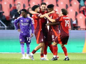 Jonathan Osorio (21) of Toronto FC celebrates with his teammates after scoring a goal in the first half of an MLS match against Orlando City at BMO Field in Toronto, Saturday, October 18, 2025.