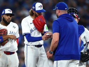 Blue Jays manager John Schneider takes the ball from starting pitcher Kevin Gausman during the seventh inning against the Dodgers in Game 2 of the 2025 World Series at the Rogers Center in Toronto, Saturday, Oct. 25, 2025.