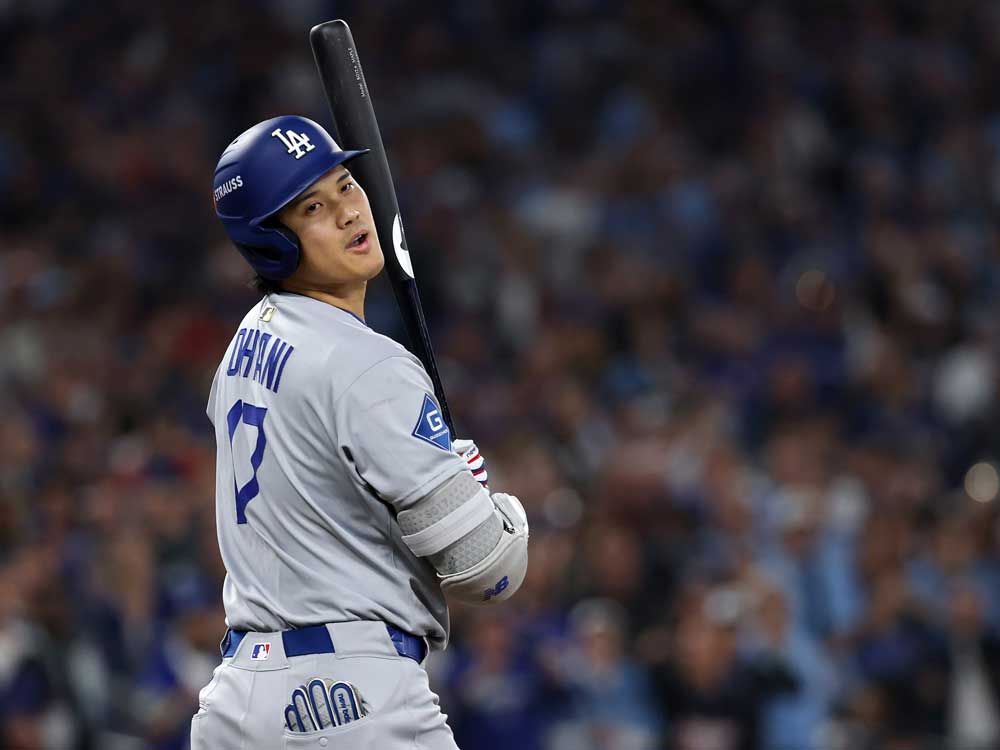 Shohei Ohtani of the Los Angeles Dodgers reacts to being hit during the fifth inning against the Toronto Blue Jays in Game 1 of the 2025 World Series at Rogers Center on October 24, 2025 in Toronto. 