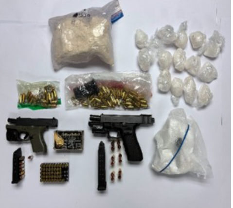 Firearms, ammo and drugs seized during two search warrants that led to numerous charges against two Toronto men.