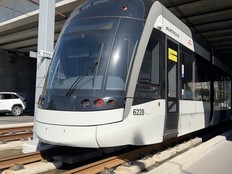 An LRT train under a bridge.