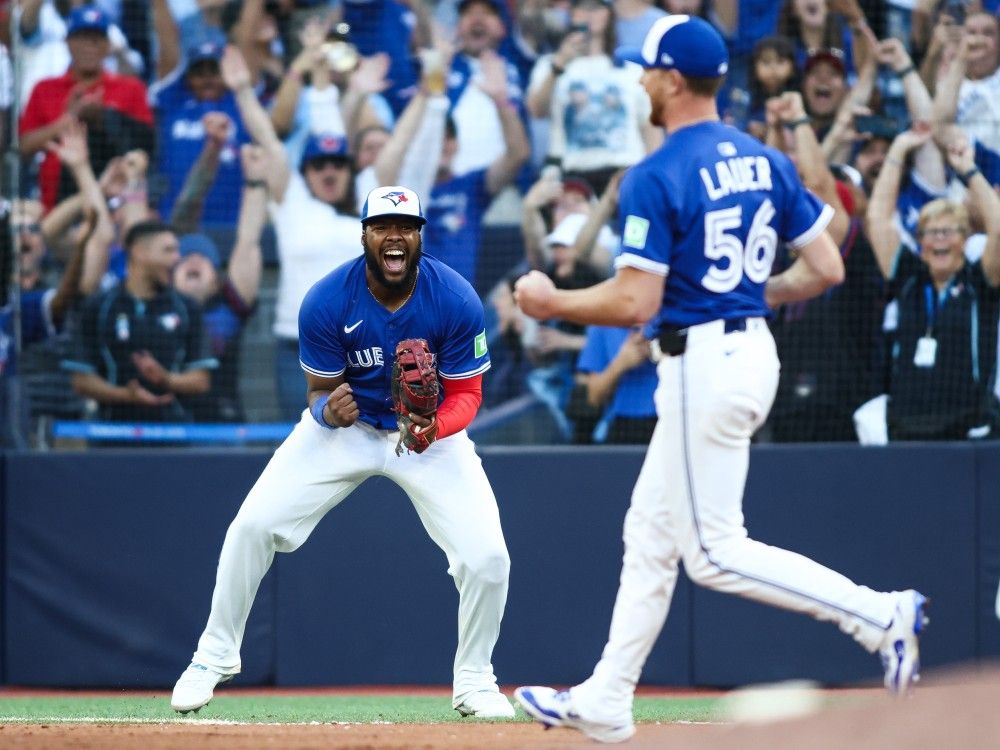 Blue Jays First Baseman Vladimir Guerrero Jr., on the left, celebrates after the team won the title of the American League of the Eastern Division at the end of its game against Tampa Bay rays in the center of Rogers in Toronto, Sunday, September 28, 2025.