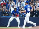 Blue Jays First Baseman Vladimir Guerrero Jr., on the left, celebrates after the team won the title of the American League of the Eastern Division at the end of its game against Tampa Bay rays in the center of Rogers in Toronto, Sunday, September 28, 2025.