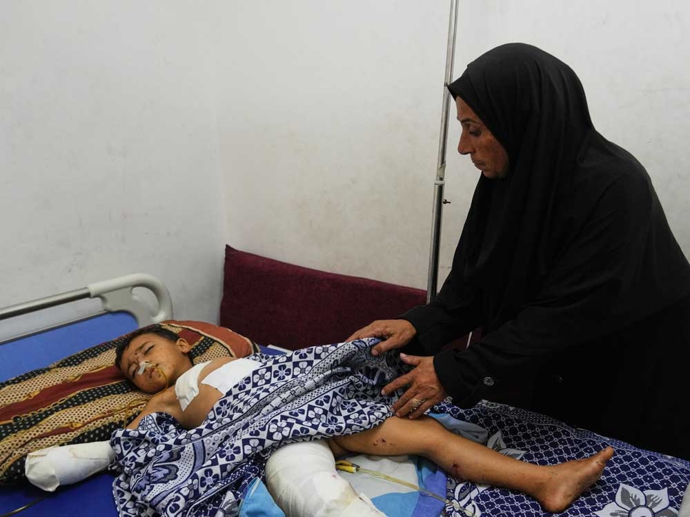 Hanan Shakshk cares for her grandson Yahya Shorbasi, who was injured by an unexploded ordnance along with his six-year-old twin sister Nabila, at Shifa Hospital in Gaza City, Saturday, Oct. 25, 2025.  Hanan Shakshk cares for her grandson Yahya Shorbasi, who was injured by an unexploded ordnance along with his six-year-old twin sister Nabila, at Shifa Hospital in Gaza City, Saturday, Oct. 25, 2025.
