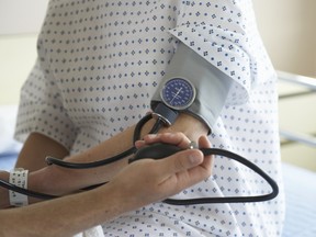 A doctor checks a woman's blood pressure.