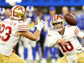 San Francisco quarterback Mac Jones tosses a pass to Christian McCaffrey in an NFL overtime victory over the Los Angeles Rams.