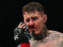Britain's Tom Aspinall reacts after being punched in the eye during his fight with France's Cyril Gane during their UFC heavyweight title bout at UFC 321 at the Etihad Arena in Abu Dhabi in the early hours of October 26, 2025.