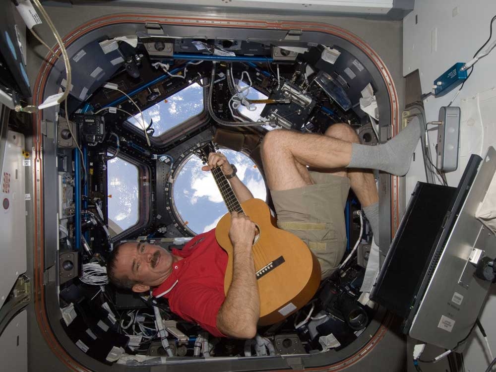 In this photo provided by NASA, Canadian astronaut Chris Hadfield plays guitar in the cupola module of the International Space Station on Dec. 25, 2012.  In this photo provided by NASA, Canadian astronaut Chris Hadfield plays guitar in the cupola module of the International Space Station on Dec. 25, 2012.
