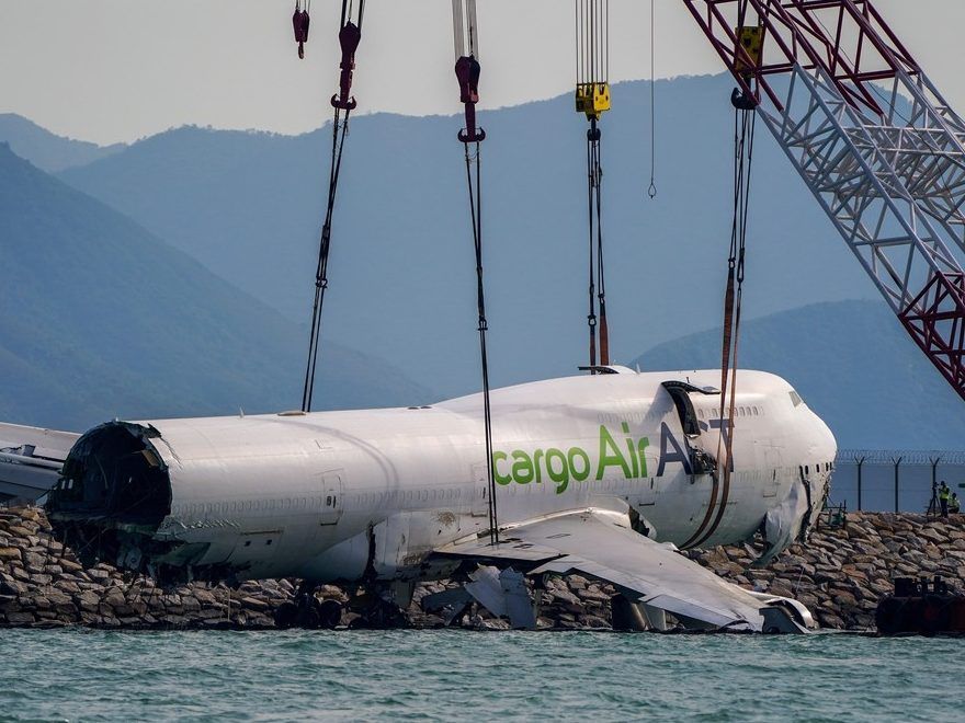 The wreckage of a cargo plane that skidded off the runway at Hong Kong International Airport is being prepared for removal on Sunday, October 26, 2025.