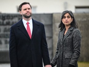 U.S. Vice President J.D. Vance, left, stands with his wife Usha Vance during a tour of the Dachau concentration camp memorial in Dachau, southern Germany, February 13, 2025.