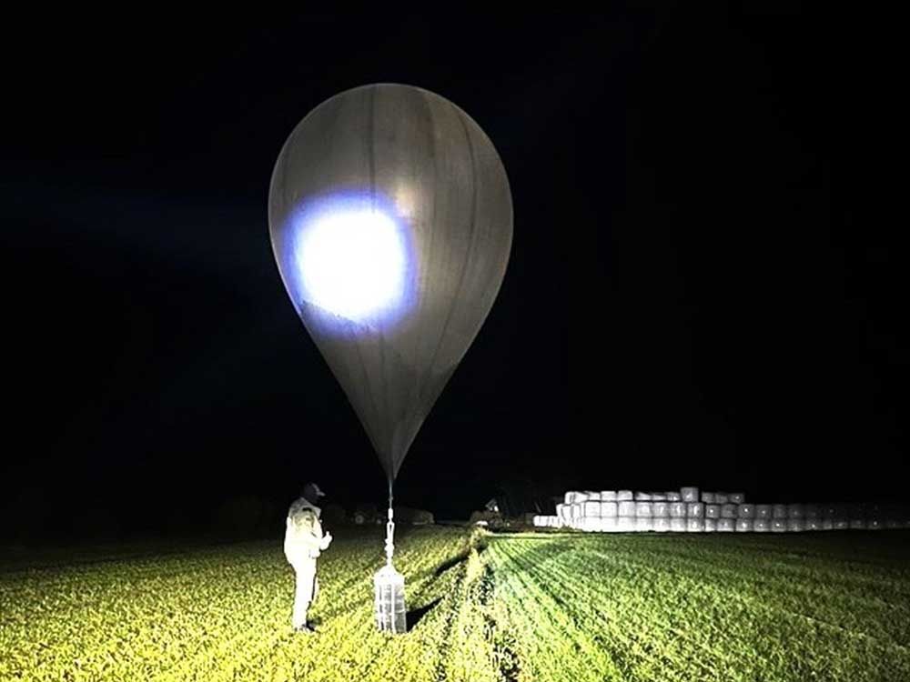 In this undivided photograph published by the public service of the border guard, the officer is inspecting the balloon used to transfer cigarettes to Lithuania, because Belarusian smugglers often use them to transport smuggling to the European Union. 