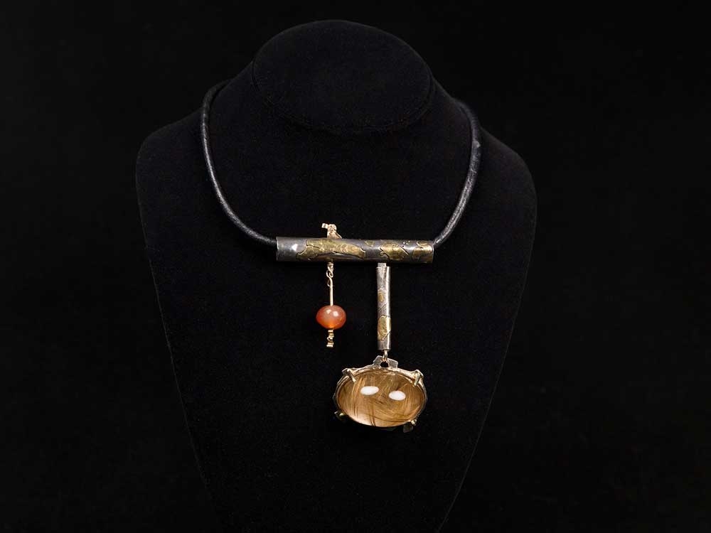 This undated photo provided by the Oakland Museum of California Thursday, Oct. 30, 2025, shows the Rutilated Quartz Dome Neckpiece by Florence Resnikoff at the Oakland Museum of California, in Oakland, Calif.  This undated photo provided by the Oakland Museum of California Thursday, Oct. 30, 2025, shows the Rutilated Quartz Dome Neckpiece by Florence Resnikoff at the Oakland Museum of California, in Oakland, Calif.
