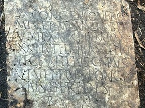 This photograph, provided by Tulane University classical archaeologist Suzanne Lusnia in October 2025, shows the Latin inscription on the 1,900-year-old tombstone of a Roman sailor named Sextus Congenius Verus, discovered in a New Orleans backyard.
