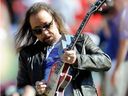In this Oct. 4, 2009 file photo, former KISS lead guitarist Ace Frehley plays the national anthem before an NFL football game between the Kansas City Chiefs and the New York Giants in Kansas City, Mo.