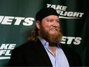 Former New York Jets center Nick Mangold poses for photographers on the green carpet ahead of an event unveiling the team's new NFL football uniforms, Thursday, April 4, 2019, in New York.