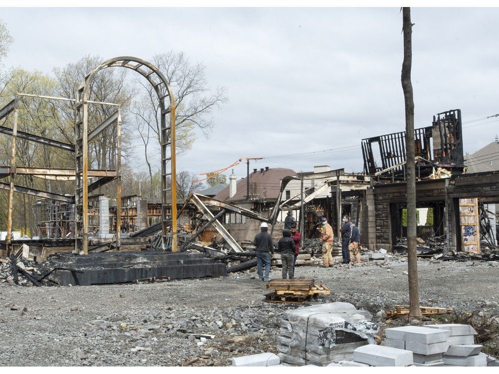 Investigators examine the scene of a fire that destroyed a $19.5-million mansion under construction on Monday, April 26, 2021 in Montreal.