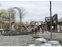 Investigators examine the scene of a fire that destroyed a $19.5-million mansion under construction on Monday, April 26, 2021 in Montreal.