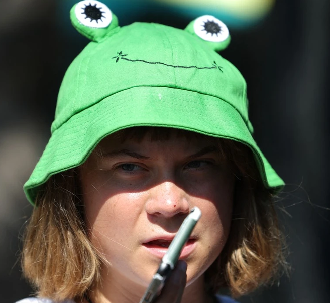 Child-like activist for all seasons, Greta Thunberg, in her famous frog hat. GETTY IMAGES  Child-like activist for all seasons, Greta Thunberg, in her famous frog hat. GETTY IMAGES