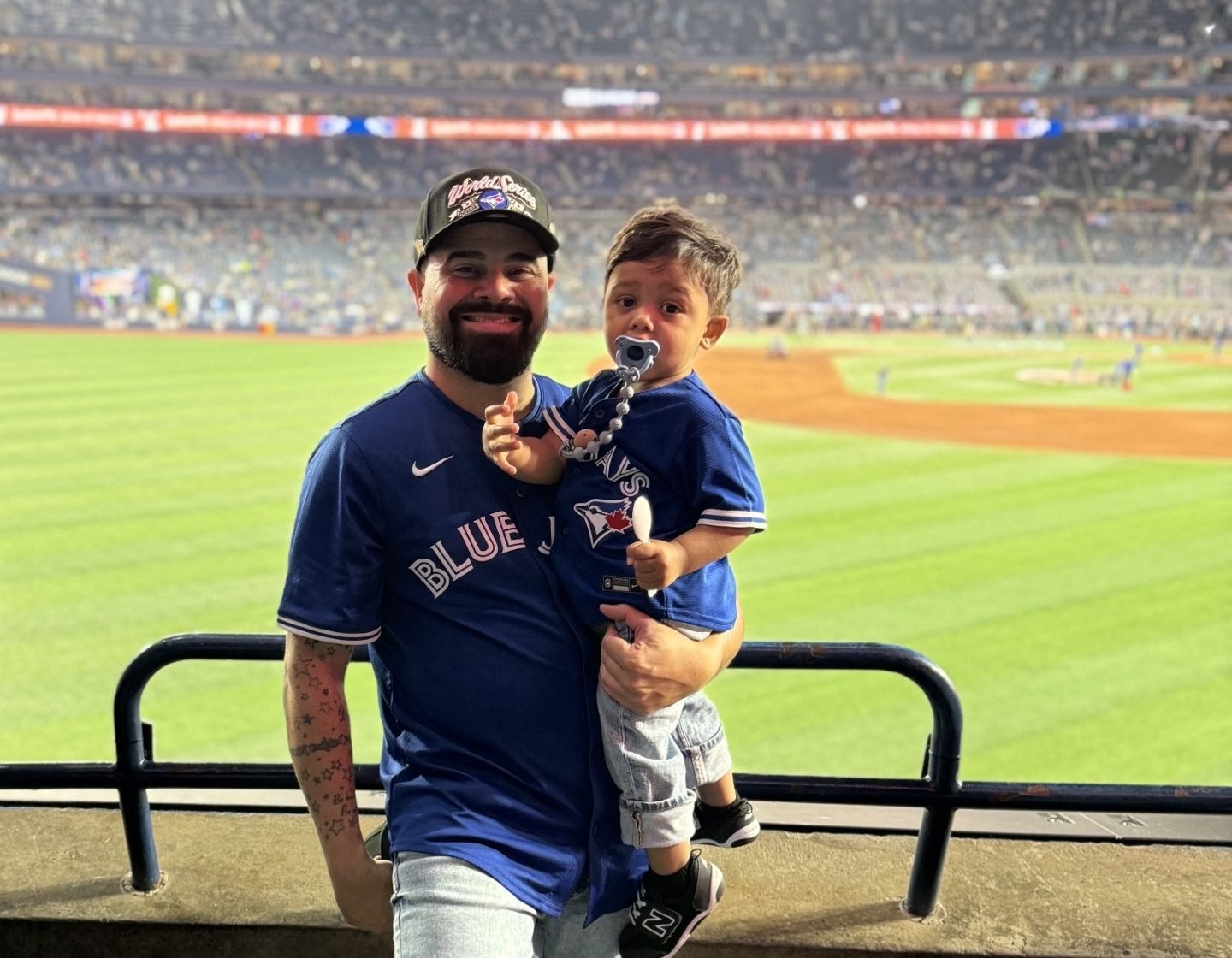 Joseph Khargie makes memories with his one-year-old son Maximus taking in the Blue Jays win over the Dodgers in Game 1 of the World Series at the Rogers Centre on Friday Oct. 24, 2025.  Joseph Khargie makes memories with his one-year-old son Maximus taking in the Blue Jays win over the Dodgers in Game 1 of the World Series at the Rogers Centre on Friday Oct. 24, 2025.