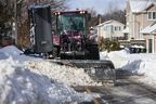 A snowplow tries to clear a path through buried cars and piles of snow on Cornell Avenue north of Kingston Road. and west of Worden Avenue on Monday, February 17, 2025.