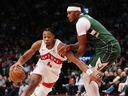 Toronto Raptors' Scotty Barnes (4) passes Milwaukee Bucks' Myles Turner (3) during Tuesday's game.