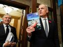 Prime Minister Mark Carney (right) holds a copy of the budget as he and Finance Minister Francois-Philippe Champagne head to the House of Commons to present the federal budget on November 4.