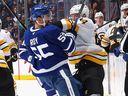 Toronto Maple Leafs’ Nicolas Roy and Tanner Jeannot of the Boston Bruins tangle during a game on Nov. 8, 2025.