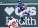 Toronto Blue Jays shortstop Bo Bichette throws to first base against the Boston Red Sox's Jarren Duran during a game earlier this year.