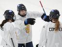 Toronto Scepter forward Blair Turnbull (center) talks with teammates during PWHL training camp.