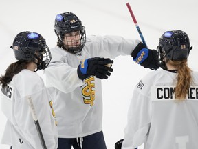 Toronto Sceptres forward Blayre Turnbull (centre) talks with teammates during PWHL training camp action.