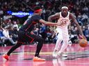 Pascal Siakam of the Indiana Pacers dribbles against Ja'Kobe Walter of the Toronto Raptors during the first half of a basketball game at Scotiabank Arena in Toronto on November 26, 2025.