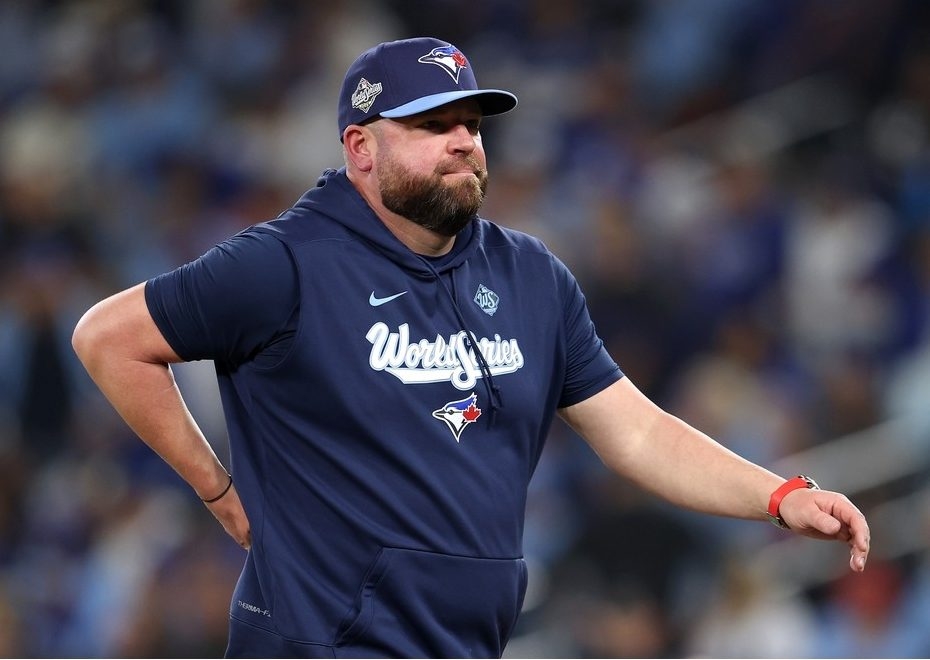  Manager John Schneider walks to the dugout after changing pitchers during the eighth inning against the Los Angeles Dodgers in Game 6 of the 2025 World Series.