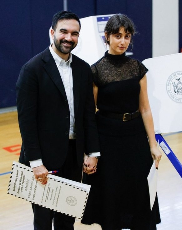  Democratic New York City mayoral candidate Zohran Mamdani holds hands with his wife Rama Duwaji after they voted at a polling location at Frank Sinatra School of Arts in the Queens borough of New York City on November 4, 2025.