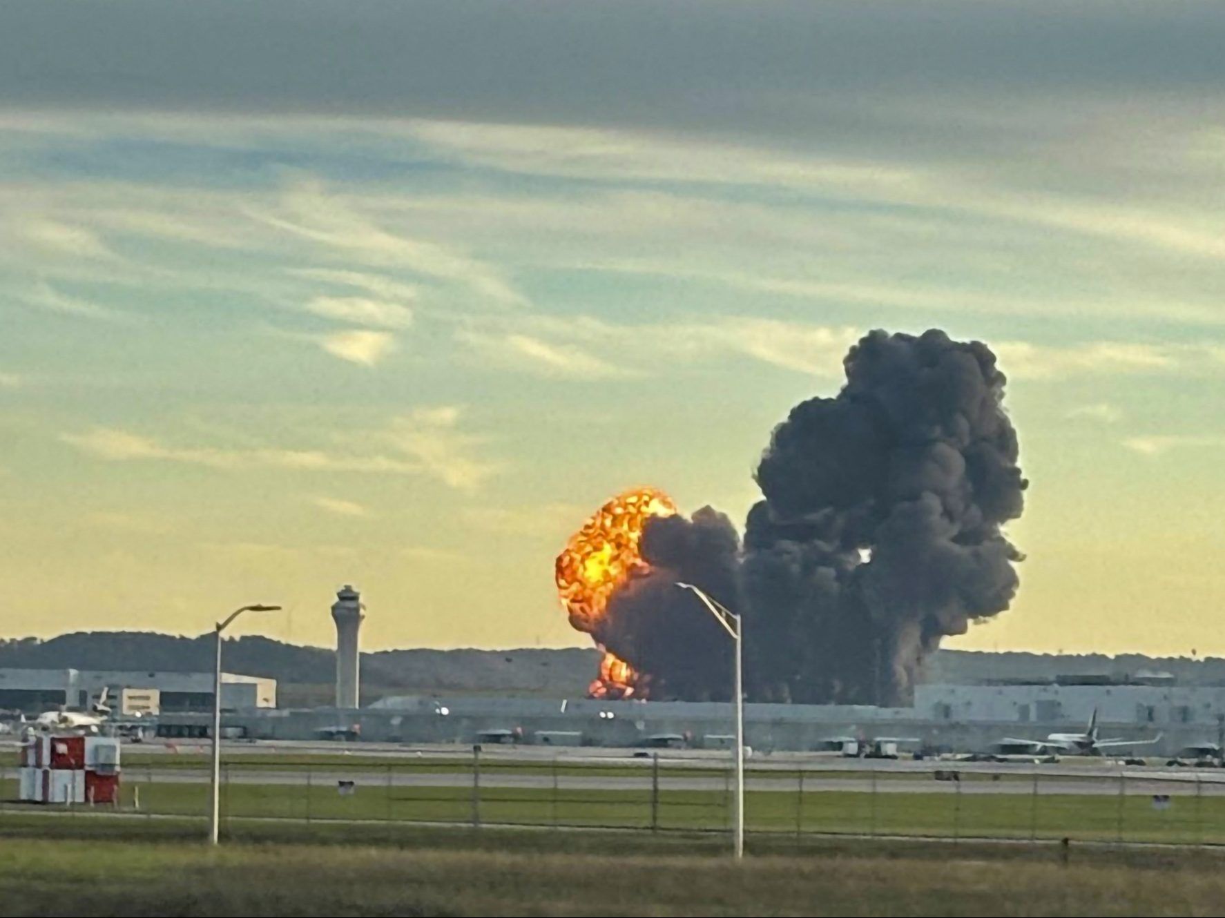 Smoke and flames rise from the site of a UPS cargo plane crash.