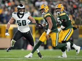 Jordan Love #10 of the Green Bay Packers runs the ball against Jaelan Phillips #50 of the Philadelphia Eagles during the third quarter of the game at Lambeau Field on November 10, 2025 in Green Bay, Wisconsin.