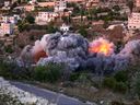 Flames and smoke billow from the site of an Israeli airstrike on a house in the village of Tahir Filsay in southern Lebanon on November 19, 2025. On November 19, the Israeli military carried out strikes on two cities in southern Lebanon, saying they were targeting the militant group Hezbollah, warning civilians of impending raids.