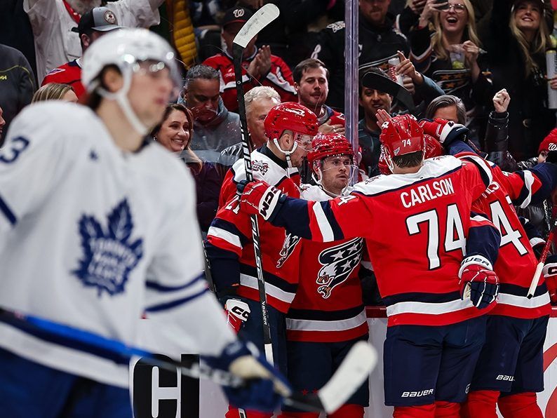 Connor McMichael  of the Capitals celebrates with teammates after scoring a goal against the Toronto Maple Leafs during the second period of the game at Capital One Arena on November 28, 2025 in Washington, DC.