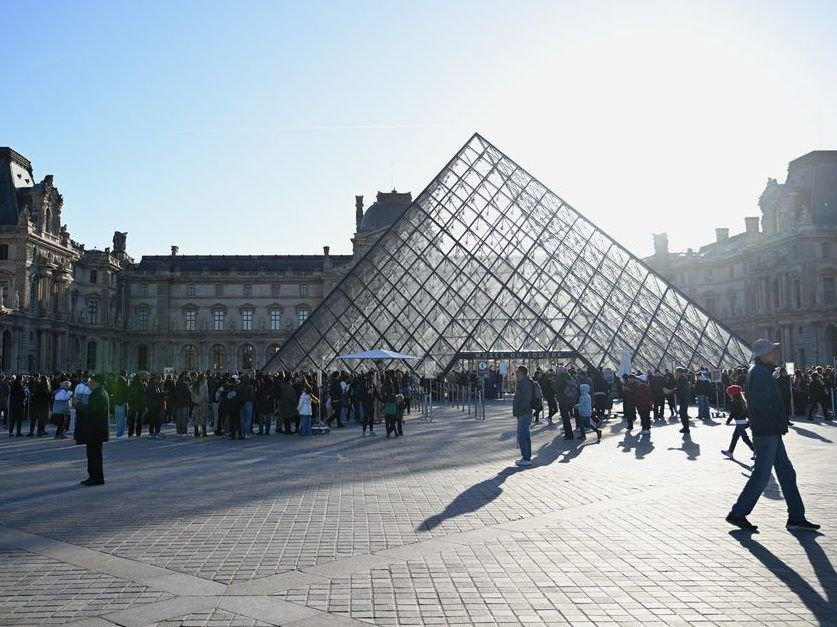 People queue to enter the Louvre museum, Thursday, Oct. 30, 2025 in Paris.