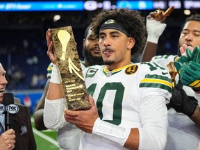 Green Bay Packers quarterback Jordan Love (10) holds the Madden Thanksgiving Day Most Valuable Player trophy after an NFL football game against the Detroit Lions in Detroit, Thursday, Nov. 27, 2025.