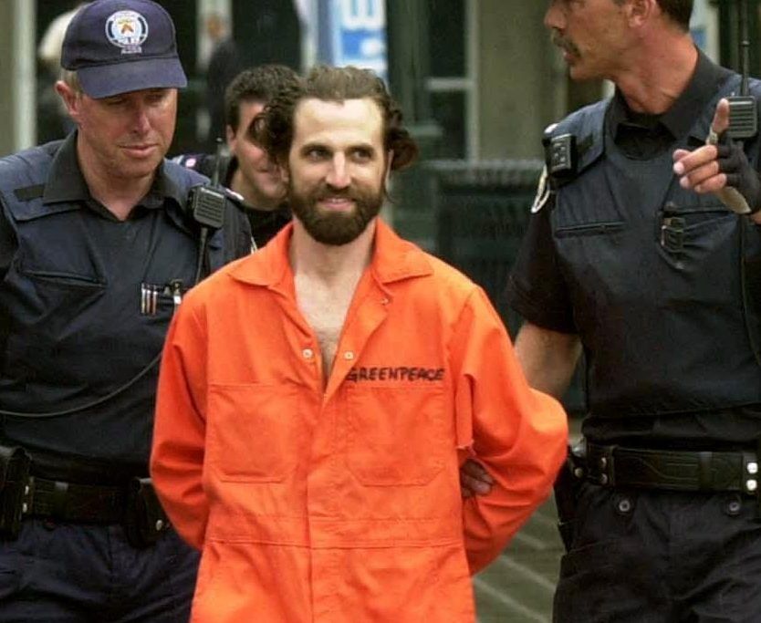 Greenpeace activist Steven Guilbeault led by officials from the CN Tower in Toronto Monday July 16, 2001.