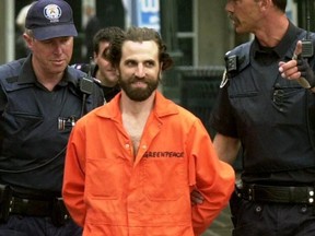 Greenpeace activist Steven Guilbeault led by officials from the CN Tower in Toronto Monday July 16, 2001.