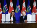 Prime Minister Mark Carney (right) signs a Memorandum of Understanding with Alberta Premier Danielle Smith in Calgary, Alta., Thursday, Nov. 27, 2025. THE CANADIAN PRESS/Jeff McIntosh