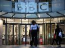 People are pictured outside the entrance to the BBC in London on Monday, Nov. 10, 2025.